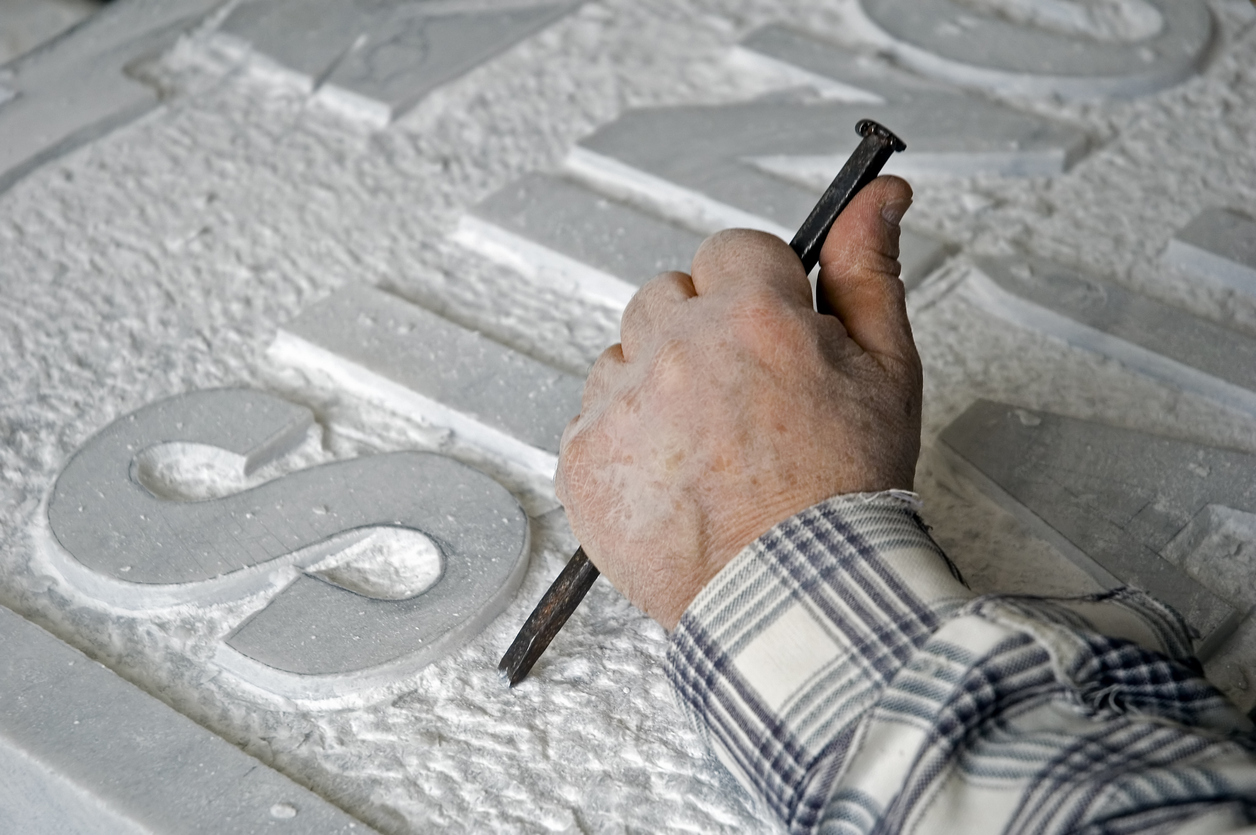 marble worker is making a tombstone.